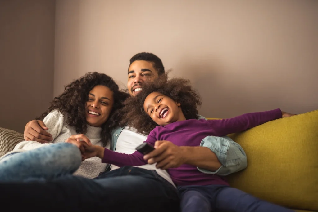 happy family watching tv together at home