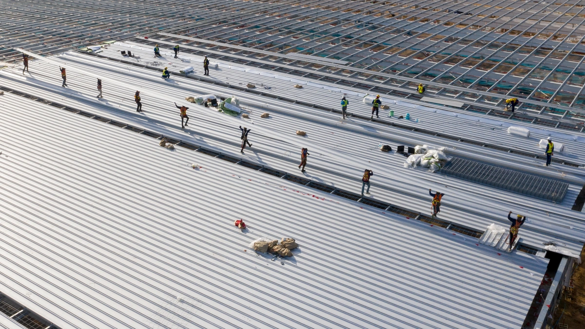 workers building new commercial roof