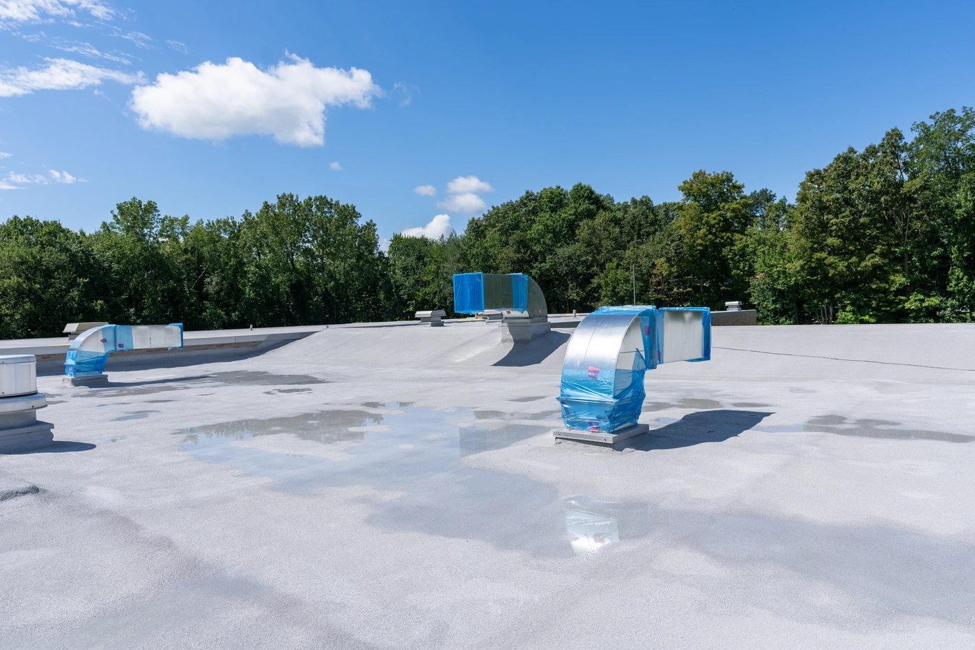 close up of flat roofing system with storm damage roof repair work