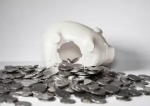 Piggybanks with money spilling to pay for divorce mediation.