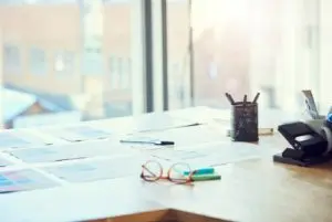 Divorce papers on a desk in New York with pens and a pair of glasses