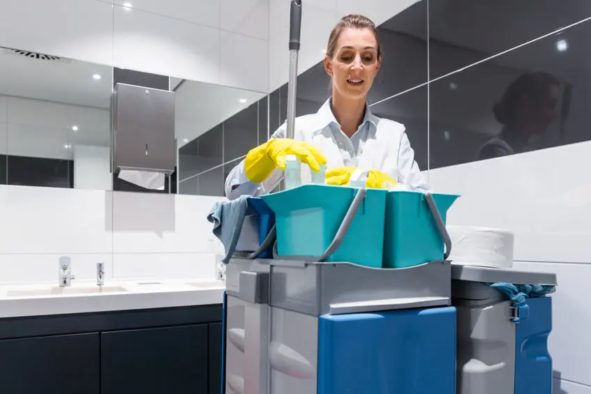 cleaner sanitizing restroom in an office building in NYC