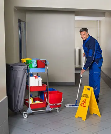 janitor mopping hallway in NYC building