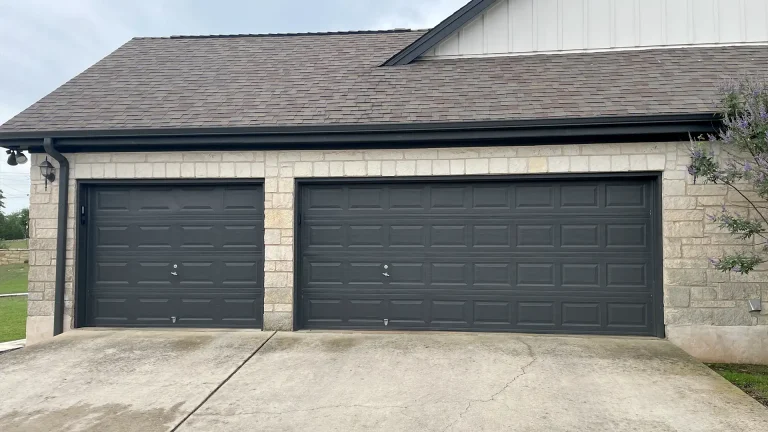 two black panelled garage doors