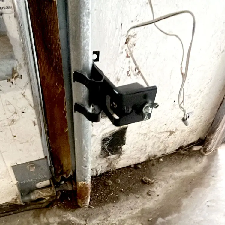 Replacement garage door safety eye installed after the original sensors shorted out in Tulsa, OK