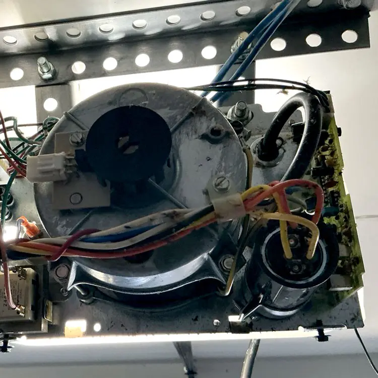 Garage door opener with a failed motor capacitor before repair in Fort Worth, Texas.