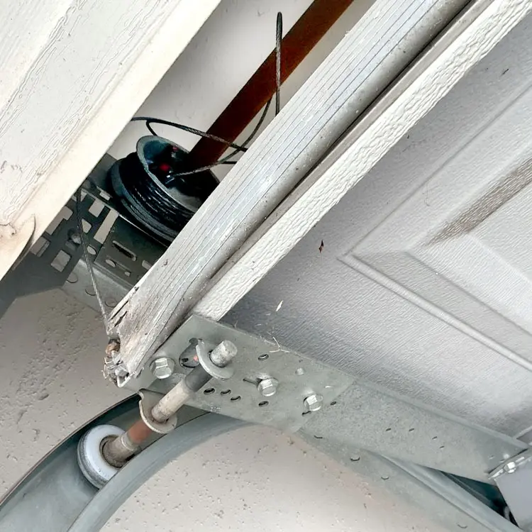 Garage door lift cable off the drum before repair in Fort Worth, Texas.