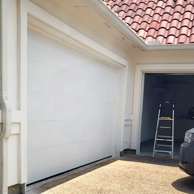 White modern flush-panel garage door after installation at an Oklahoma City, OK home