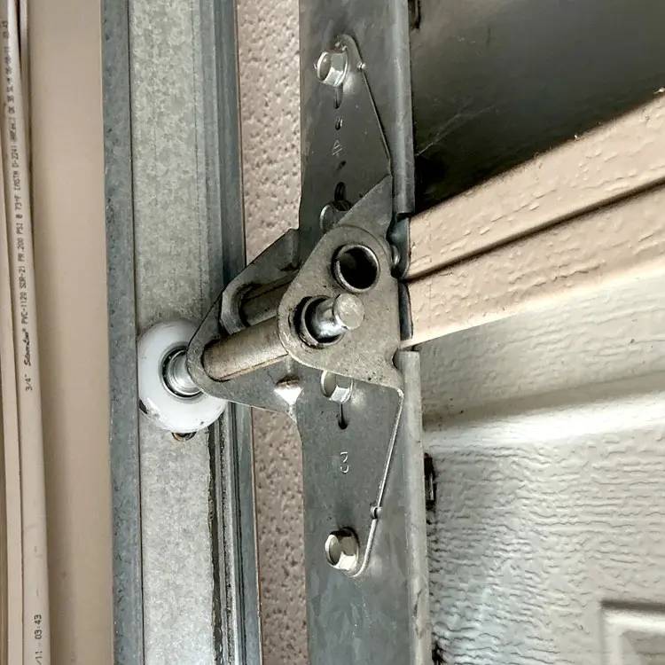 Replacement nylon garage door roller installed in the track at an Austin, TX home