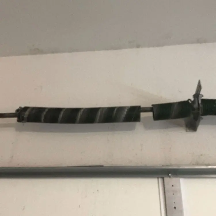 Broken torsion spring on a four-spring garage door system at a home in Dallas, TX.