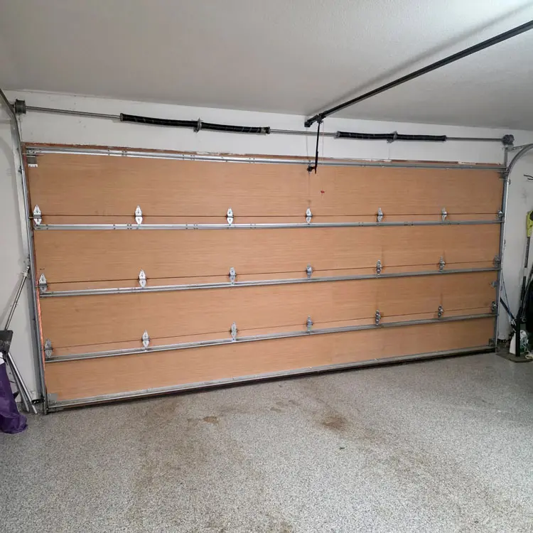 Garage door with four new torsion springs after spring replacement in Fort Worth, Texas.