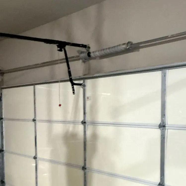 New torsion spring installed above a residential garage door in Tulsa, OK