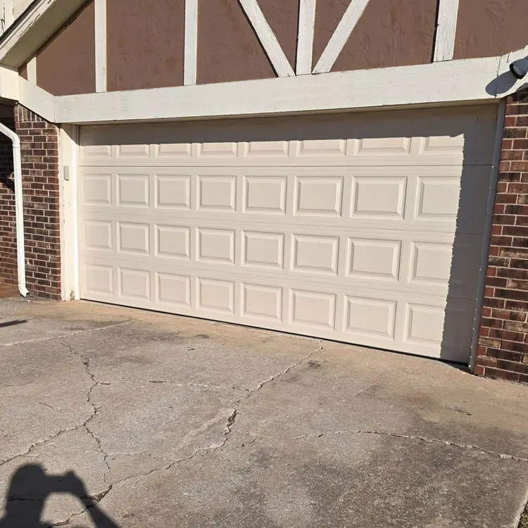 New white raised-panel garage door after replacing a door with cracked panels in Oklahoma City, OK