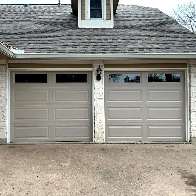 Two modern garage doors with dark glass installed at an Austin, TX home