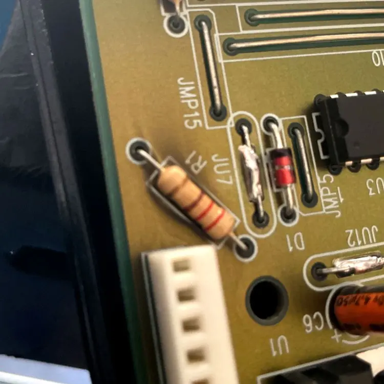 Damaged garage door opener circuit board diagnosed after a power surge caused intermittent remote operation in Dallas, TX.