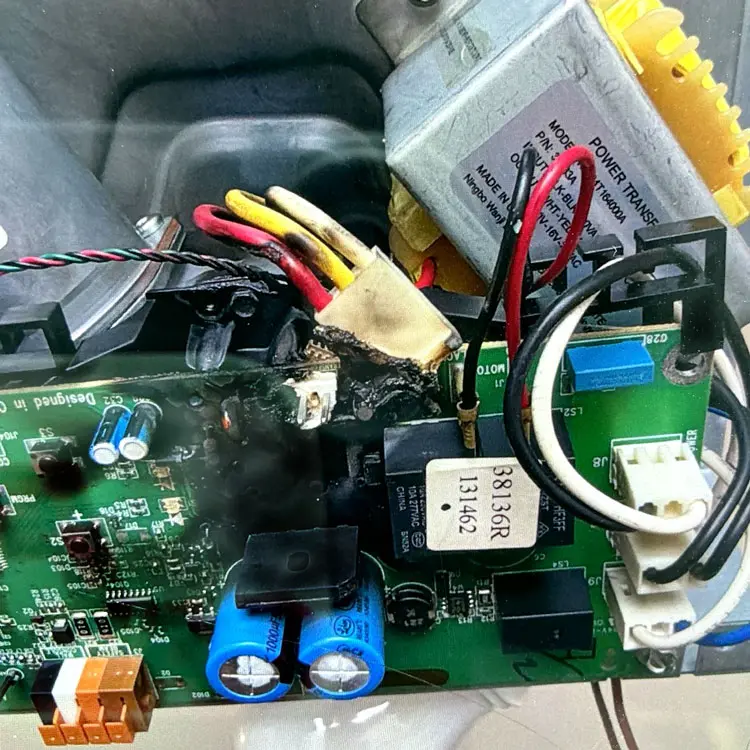 Melted garage door opener circuit board and burned wiring caused by a power surge in San Antonio, TX