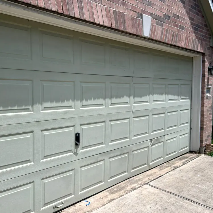 Pinched bottom garage door panel causing unstable movement in Houston, TX