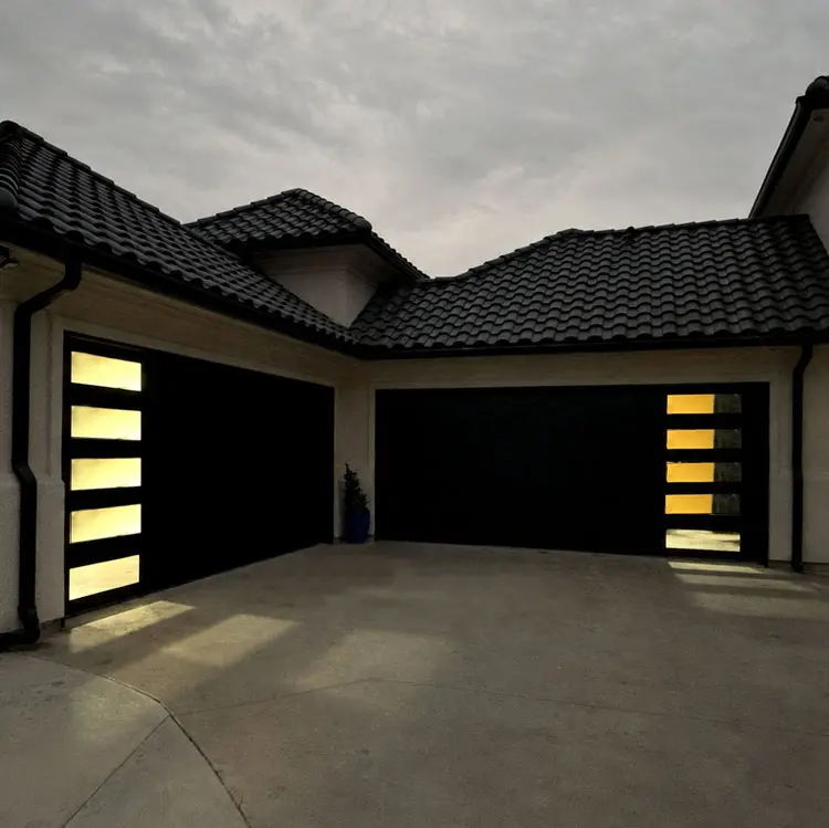 Two black modern garage doors with vertical side windows after installation at a Tulsa, OK home