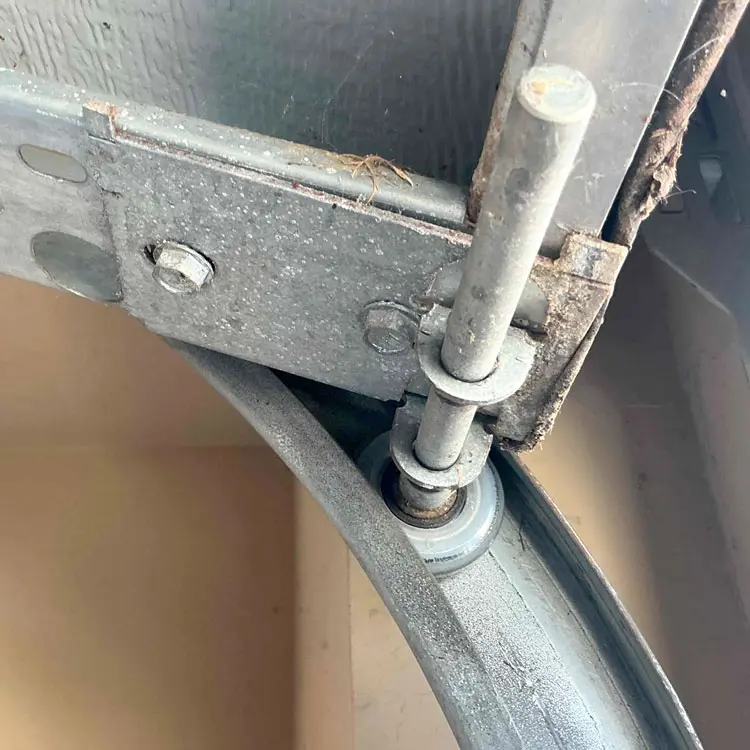 New long-stem roller installed in the bottom garage door fixture after maintenance in Oklahoma City, OK