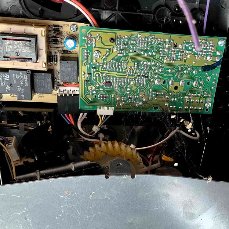Internal garage door opener circuit board during capacitor replacement in Tulsa, OK