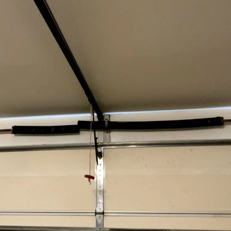 Broken garage door torsion spring with a visible separation in Houston, TX