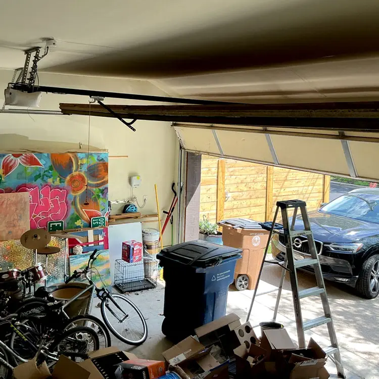 Garage door stuck partially open after a jammed roller bent a section in Austin, TX