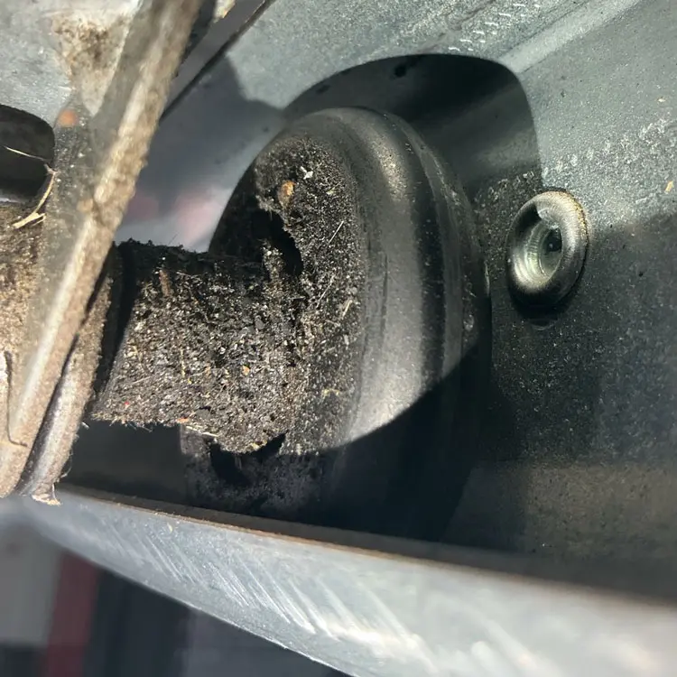Close-up of a severely worn nylon garage door roller replaced during a repair in Dallas, TX.