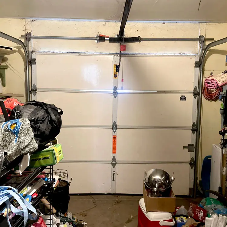 Garage door panels separating after the door continued operating with a broken torsion spring in Oklahoma City, OK