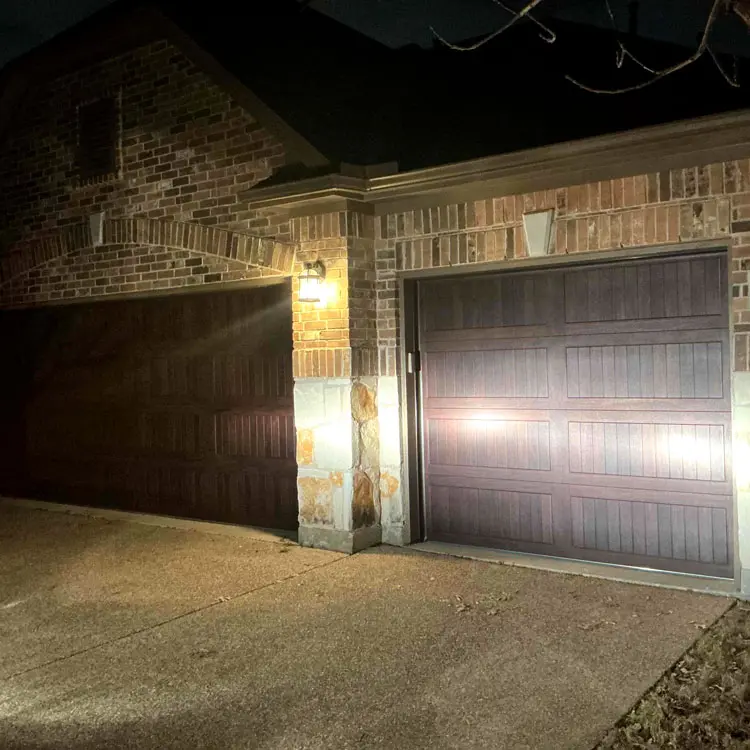 Wood-grain carriage-style double-steel garage doors after installation at a Tulsa, OK home