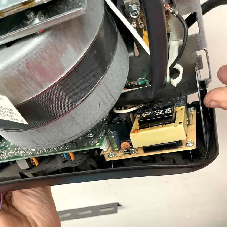 Failed capacitor inside a LiftMaster screw drive garage door opener diagnosed during a repair in Dallas, TX.