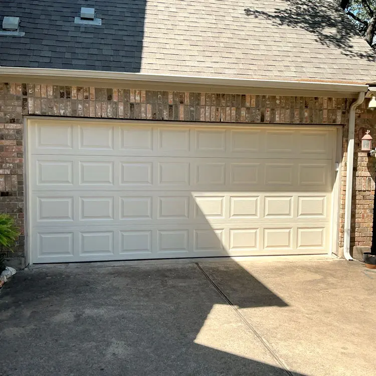 New almond color 24-gauge insulated steel garage door installed at an Austin, TX home