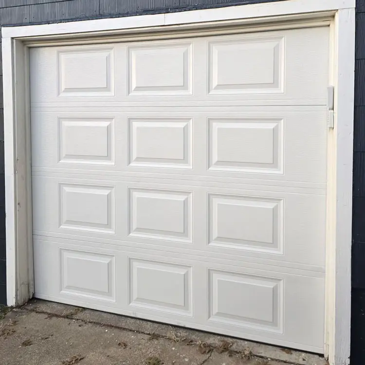 New white raised-panel garage door after replacing a deteriorated wood door at a Tulsa, OK home