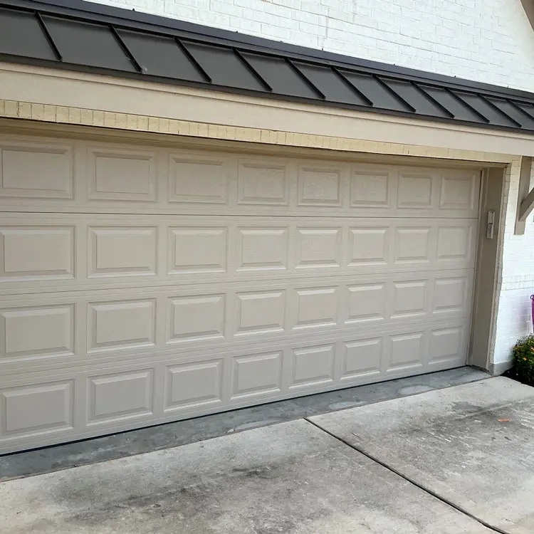New windowless raised-panel garage door installed at an Austin, TX home