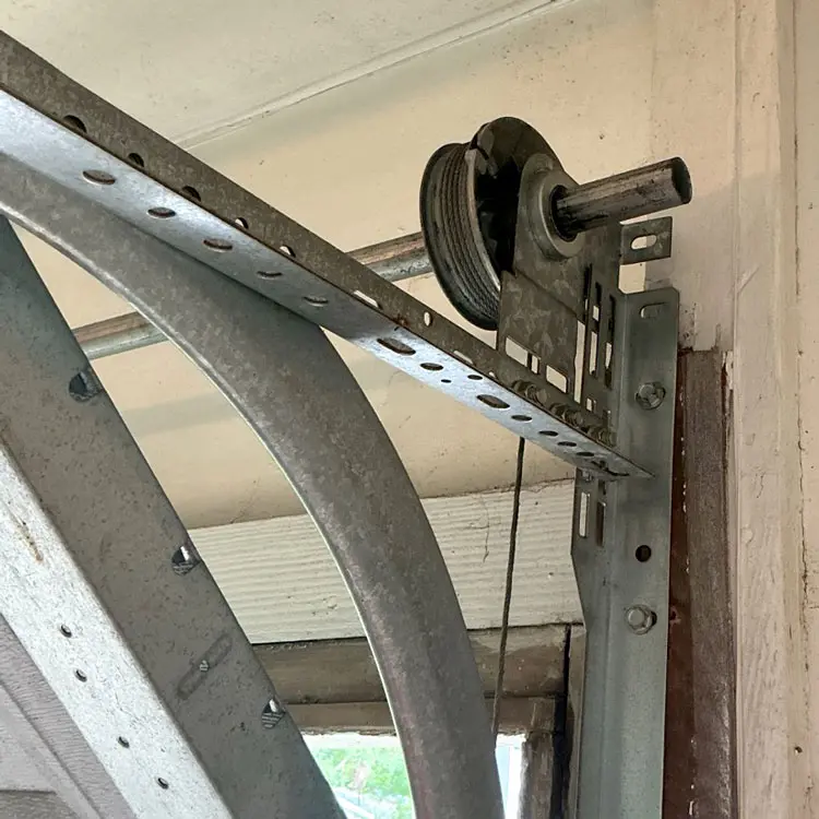Replaced garage door cable drum beside the end-bearing plate in Houston, TX