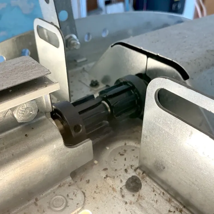 Broken garage door opener coupler before replacement in Benbrook, Texas.