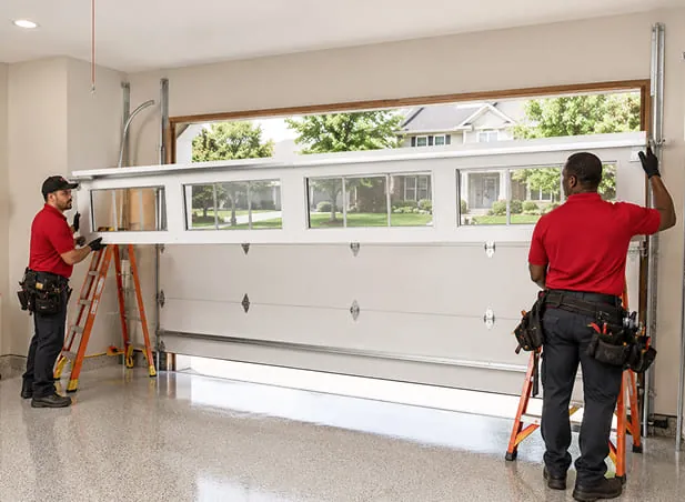 two garage door technicians installing white garage door on a single-family home