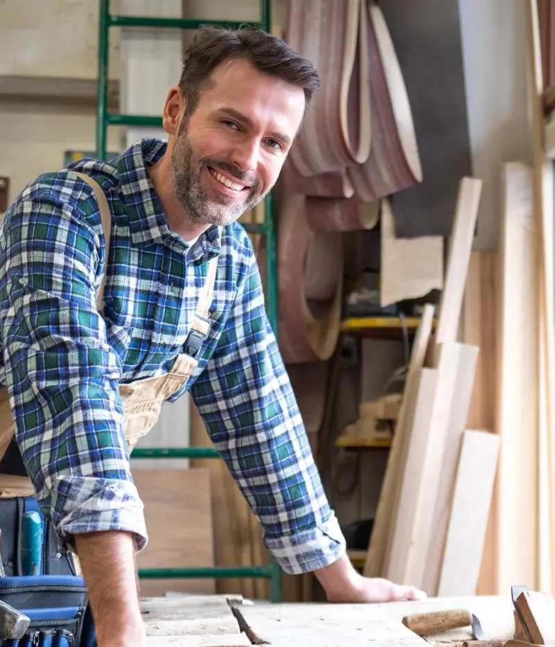 Smiling Portland Construction & Restoration carpenter at a job site