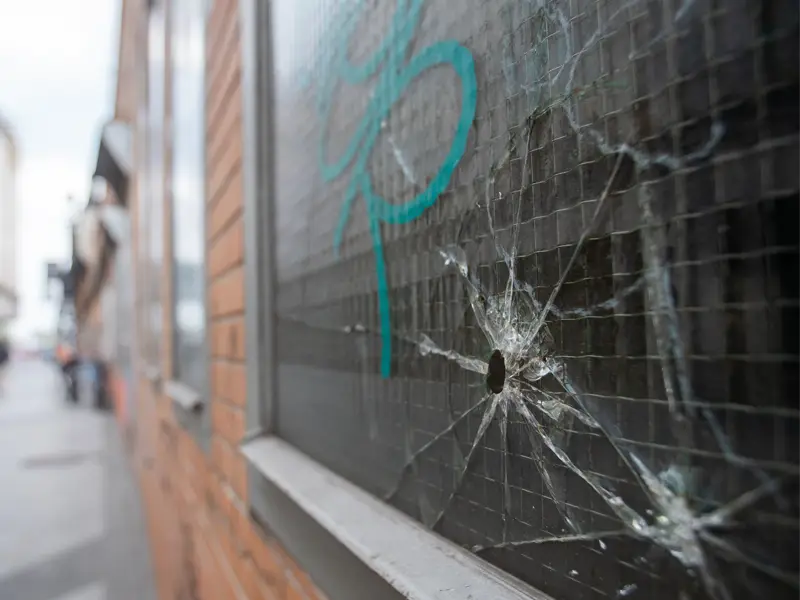 Vandalized building windows awaiting repair in Portland, OR