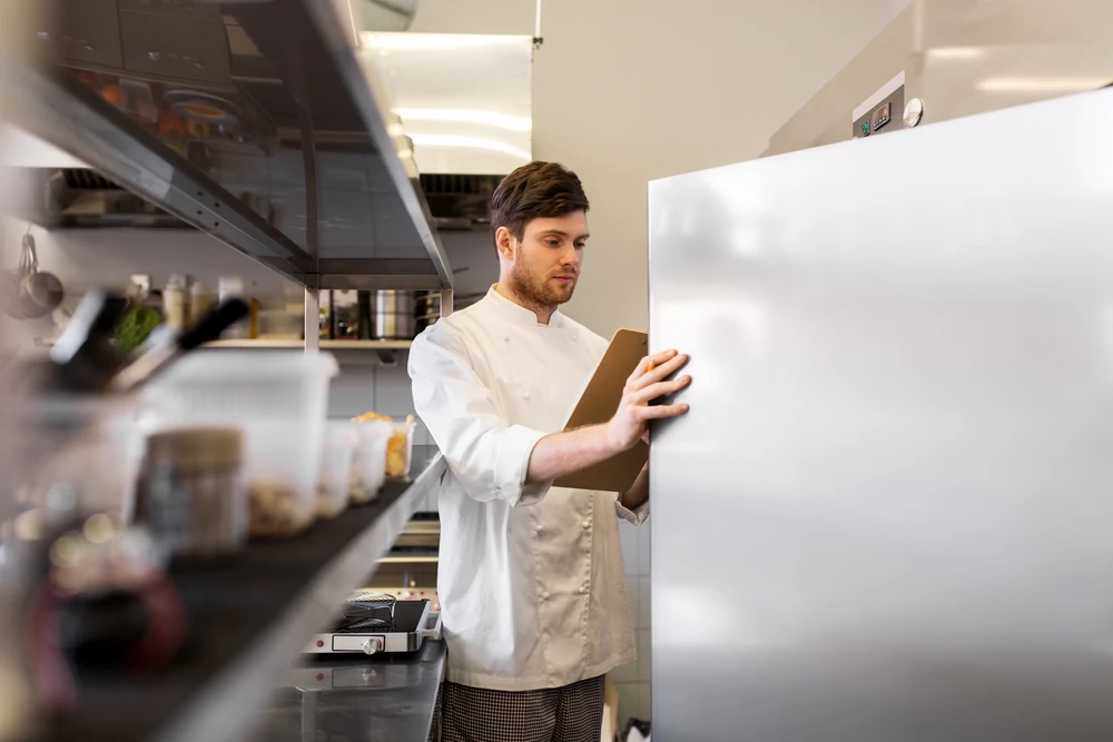 Professional chef opening restaurant fridge