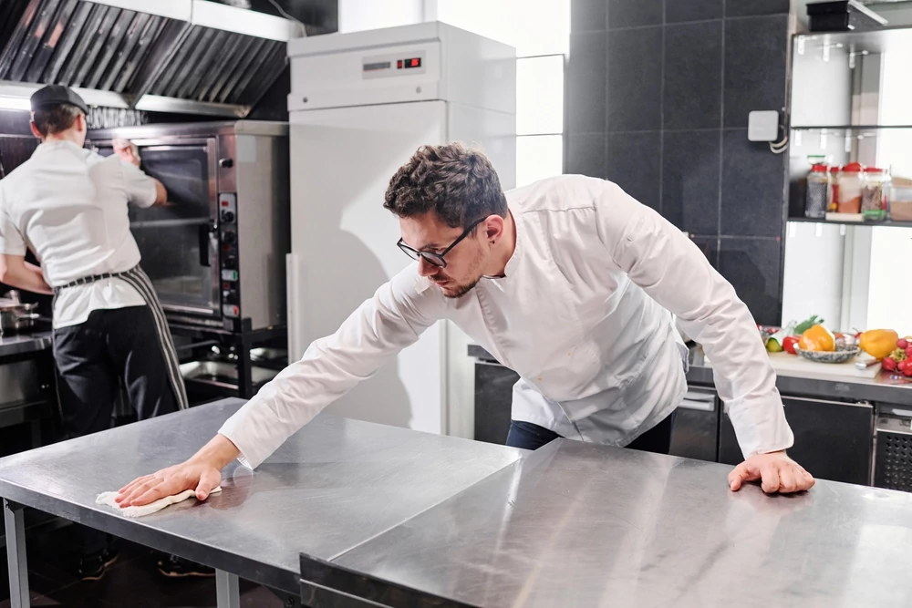 Staff cleaning kitchen after work