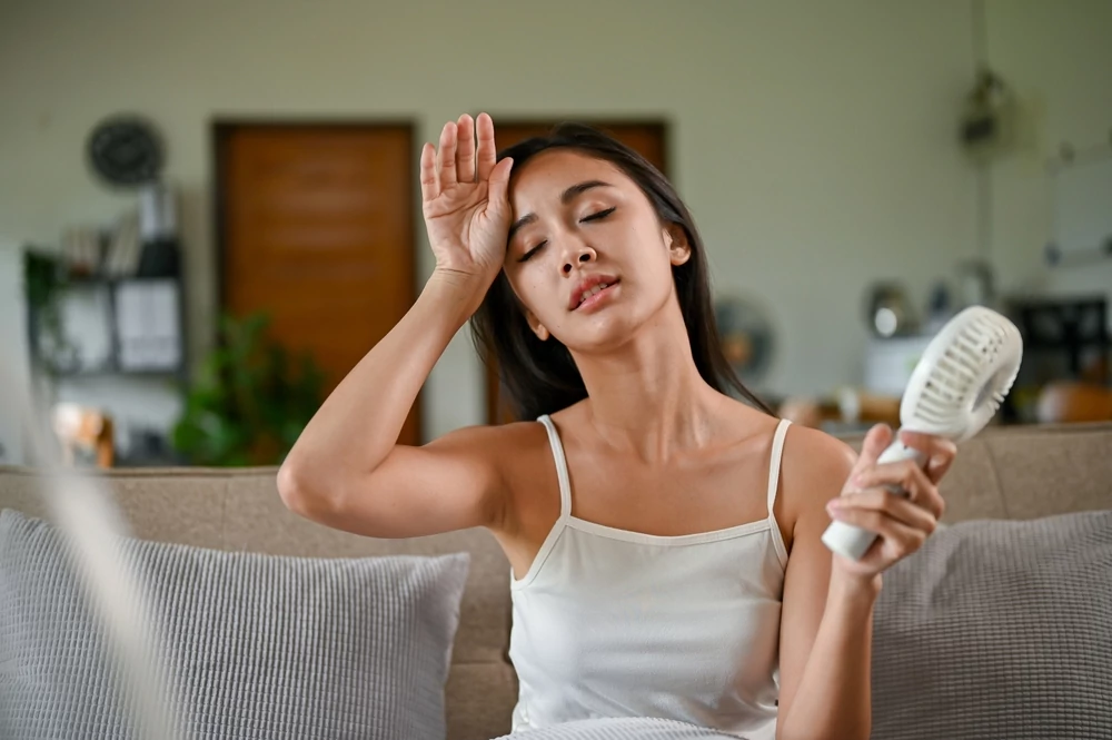 Woman feeling the heat because of broken AC