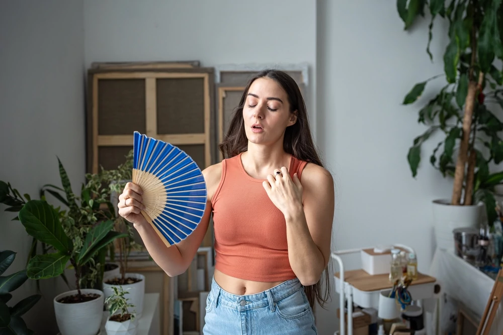 Woman suffering indoor heat