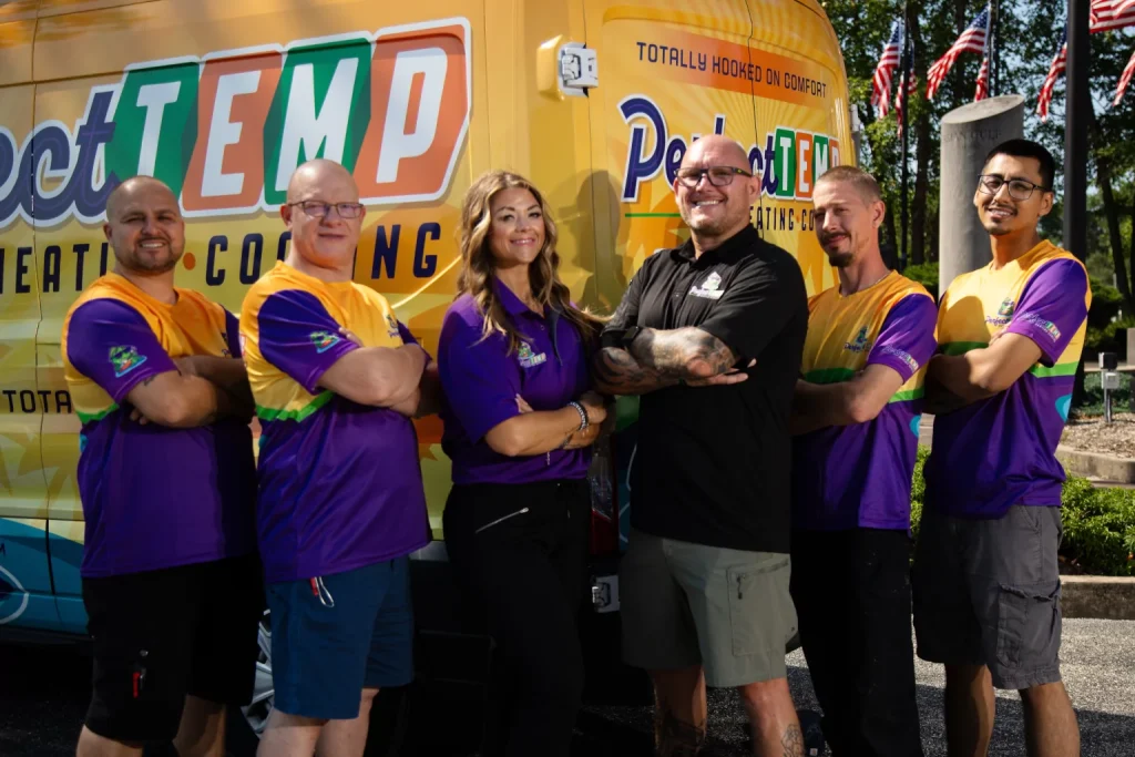perfect temp team arms crossed next to van