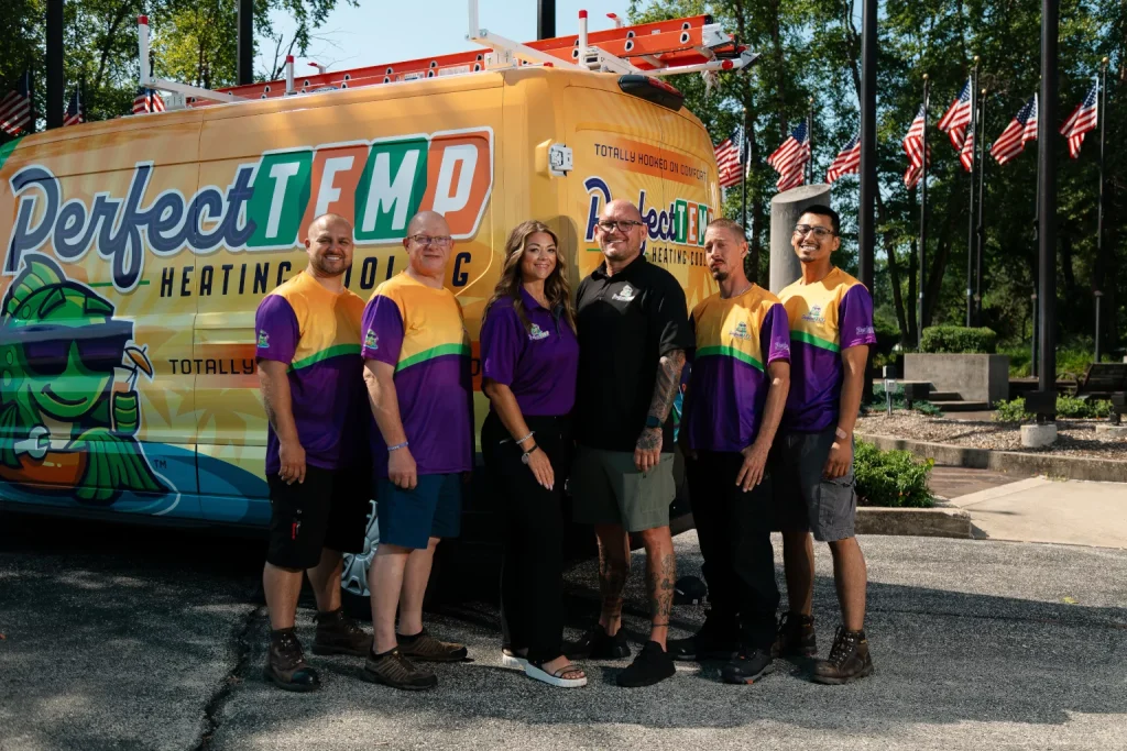 perfect temp team smiling next to van