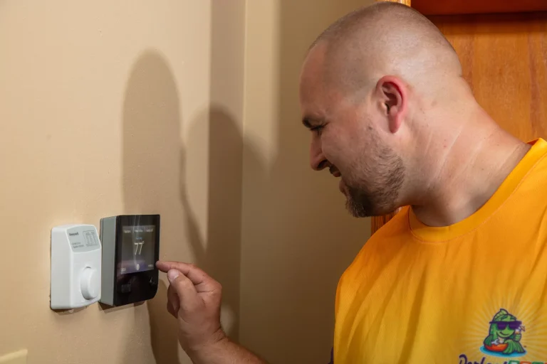 perfect temp technician looking at thermostat