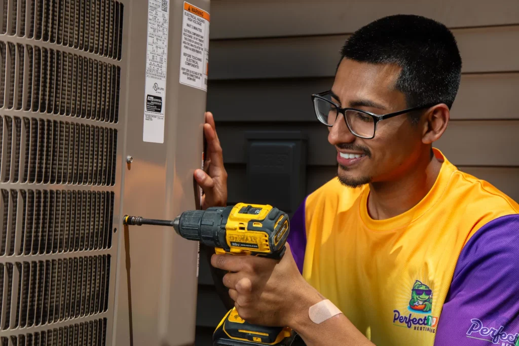 perfect temp worker holding a drill next to a heat pump