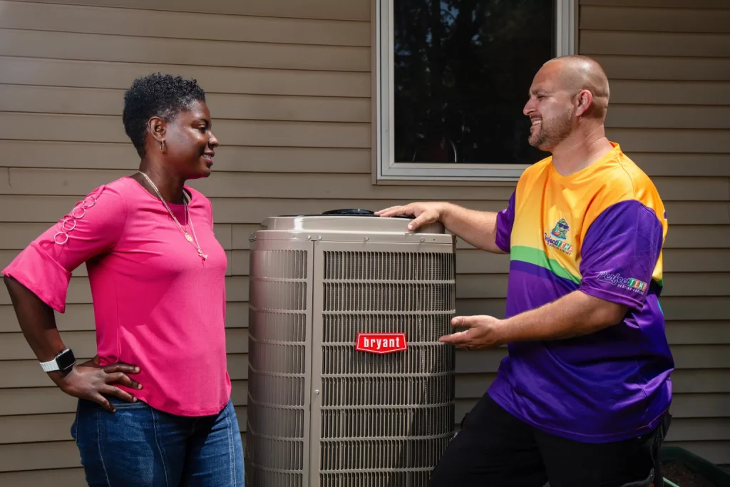 smiling homeowner listening to perfect temp technician