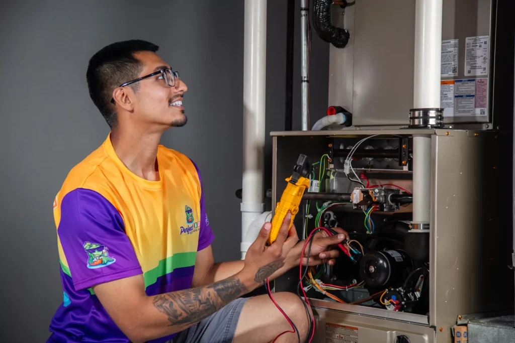 smiling perfect temp worker next to a furnace