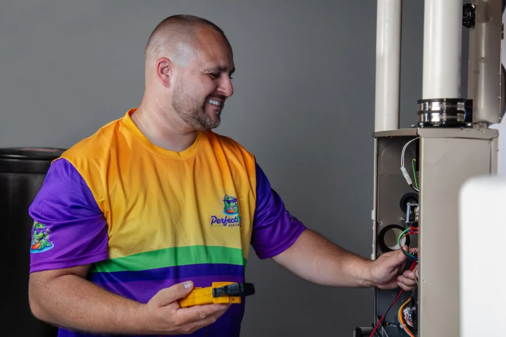 smiling technician inspecting furnace