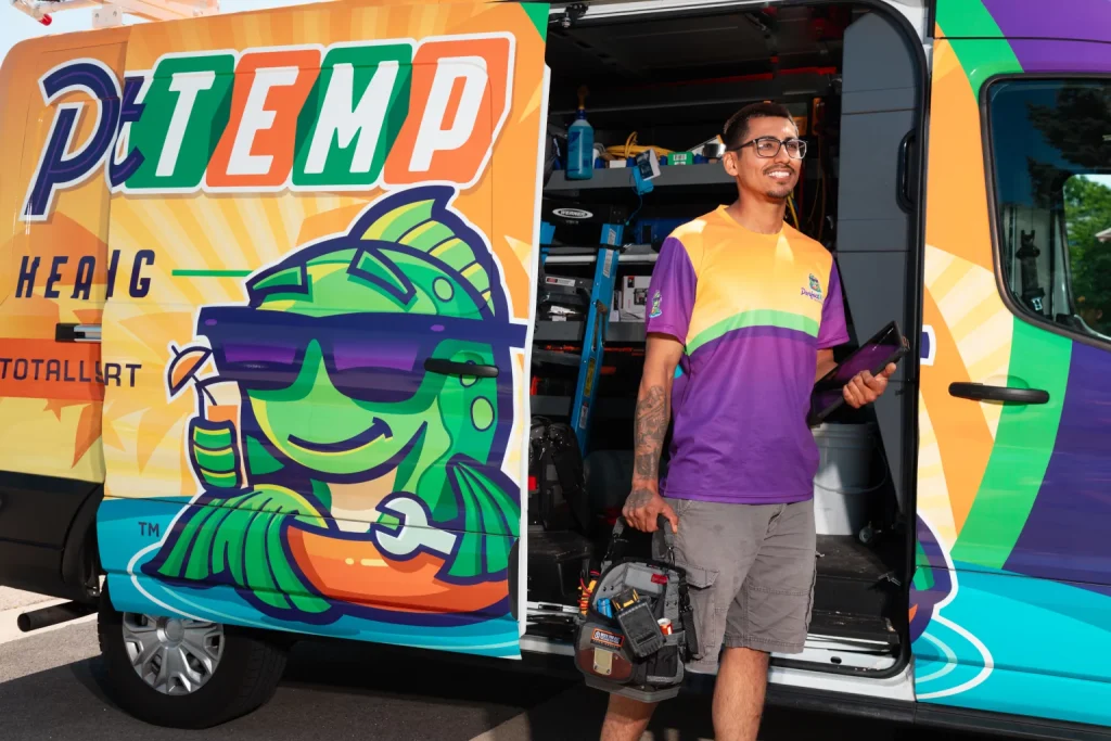 smiling technician with tools getting out of perfect temp van